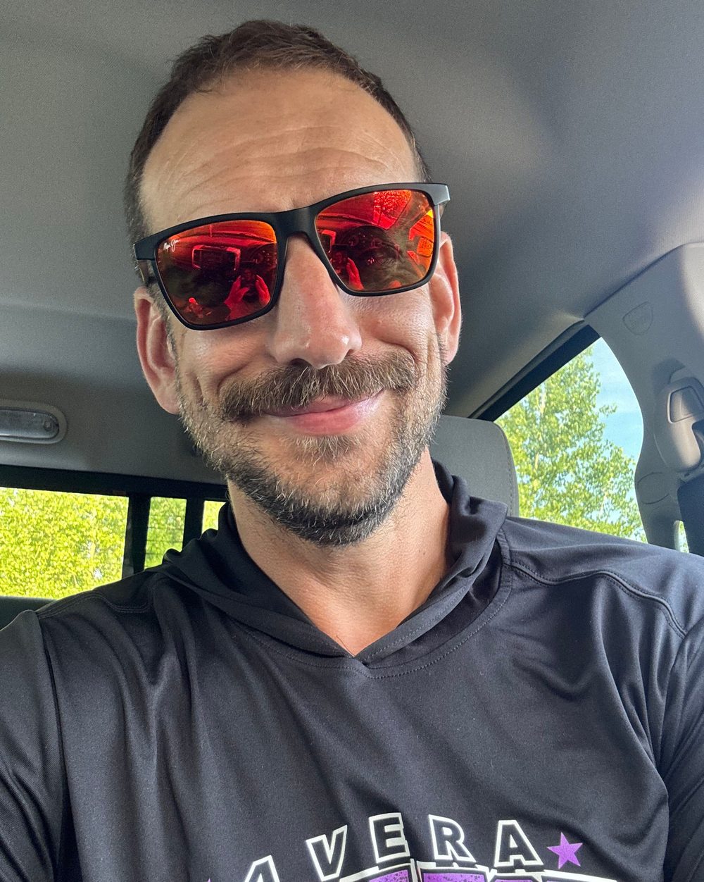 Eric Hall car selfie wearing sunglasses